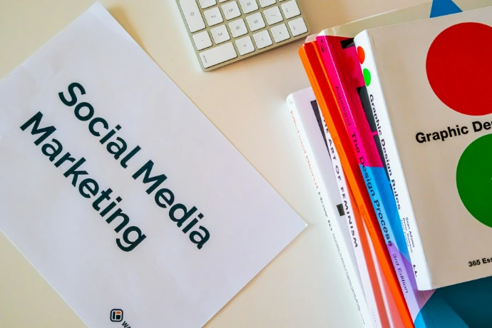 a sign that says social media marketing next to a keyboard